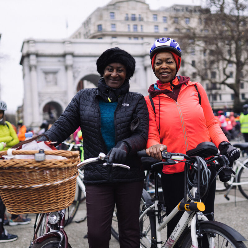 Woman with Dutch bike and basket next to friend at LCC protest